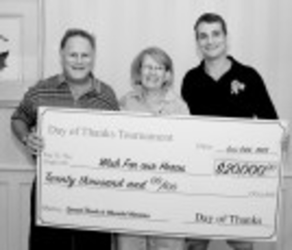 Although the oversize check, above, says “$20,000,” this year’s fundraiser brought in more than $25,000.  Buddy Trinkle, from left, Sharon Teich and Jeff Wells, from Wish for our Heroes, pose with the check. 